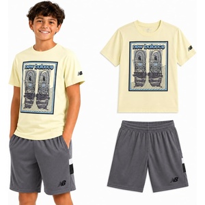 New Balance Boys 2 Piece Cotton Blend Jersey Shirt & Basketball Shorts | Bold Front Design, Breathable Short Sleeve Top, Flexible Fit Built for Sports, Play & Confident Everyday Youth Style(Yellow Grey)